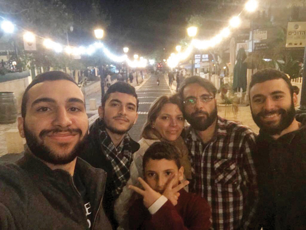 Bishara and Sarah Sakhnini and their four sons pose for a selfie on Ben Yehuda Street in Jerusalem. Picture courtesy of maozisrael.org.