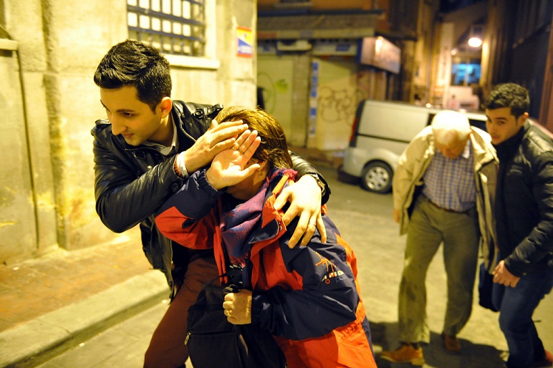 People flee the attacks in Istanbul, which killed at least 10. See Photo Credits.