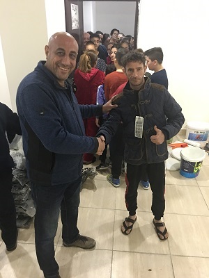 Dr Rabee at the “Rock Refugee Camp” in Erbil. These people come mostly from Syria. We were able to buy them 200+ beautiful jackets for the winter. 
