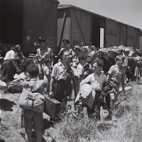 Holocaust survivors alight at Atlit refugee camp, 1945.