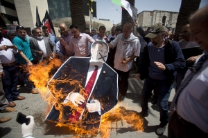 Palestinians burn a cutout of US Secretary of State Mike Pompeo